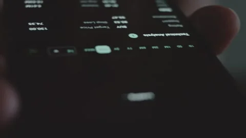 Trader investor analyst using mobile phone app. Analytics for financial stock Stock Footage 250360568