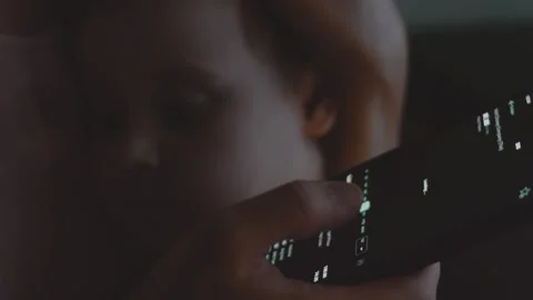 Trader investor analyst using mobile phone app while holding her child, toddler Stock Footage 250360749