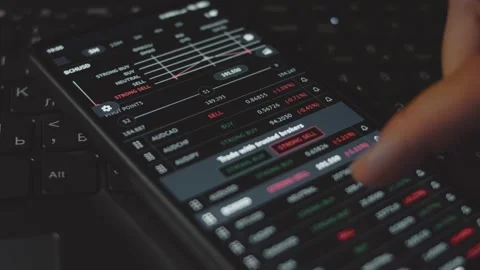 Trader investor analyst using mobile phone app. Analytics for cryptocurrency Stock Footage 250362111