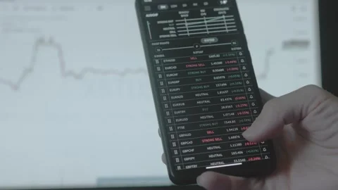 Trader investor analyst using mobile phone app and computer. Analytics for Stock Footage 250362443