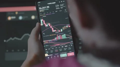 Trader investor analyst using mobile phone app and computer. Analytics for Stock Footage 250363858