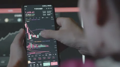 Trader investor analyst using mobile phone app and computer. Analytics for Stock Footage 250363904
