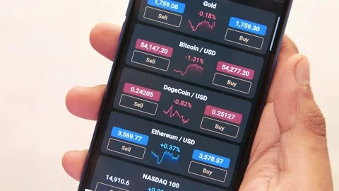 The trader looking at buy or sell option of cryptocurrencies in Smartphone App . Stock Footage 162481576