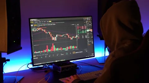 A trader looking at financial chart trading bitcoin and cryptocurrency in Stock Footage 149456424