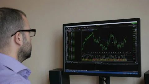 Trader is looking at financial charts on the computer monitor. Bitcoin, crypt Stock Footage 92346960
