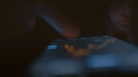 An trader looks at the changes in the digital chart of the fall process in the Stock Footage 236423940