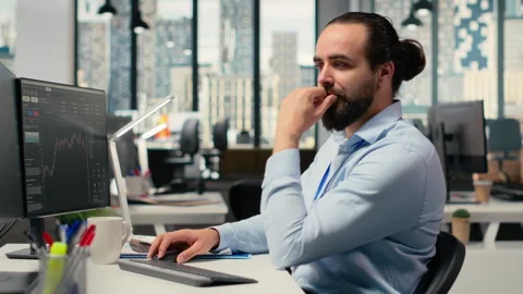 Trader in office doing brainstorming before committing to investment Stock Footage 315142042