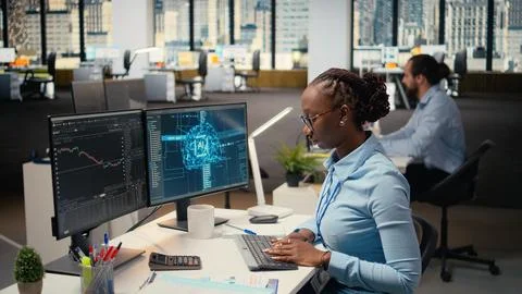 Trader in office leverages AI technology on PC to interpret analytics charts Stock Photos