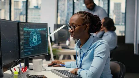 Trader in office leverages AI technology on PC to interpret analytics charts Stock Photos