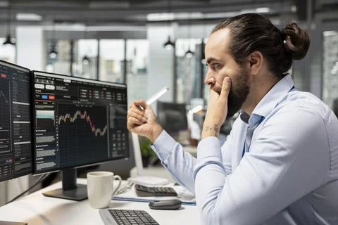 Trader in prop firm office using AI machine learning to analyze market data Stock Photos
