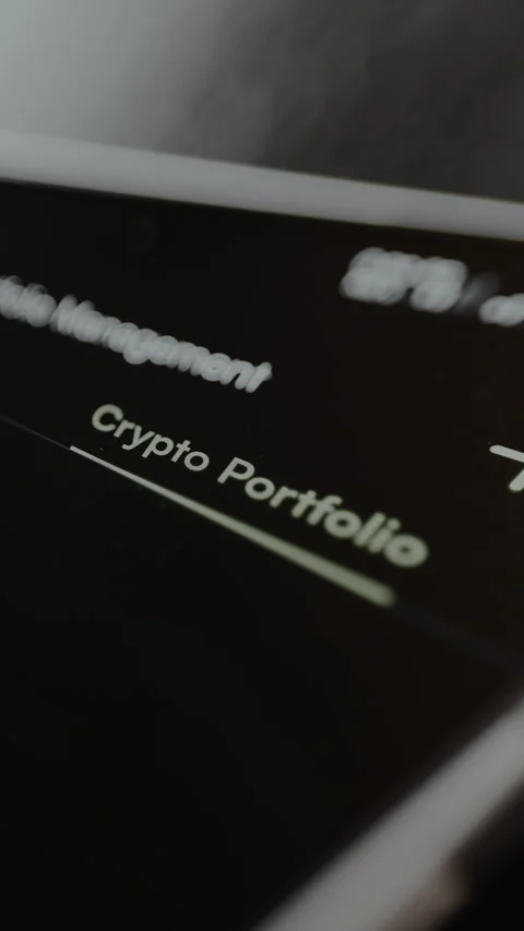 Trader taps the option Crypto Portfolio within the interface of a platform Stock Footage 328882192
