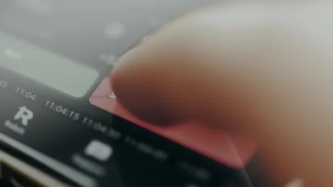 Trader taps the SELL red button within a financial trading app Stock Footage 330252598