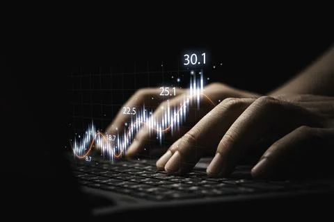 Trader using laptop computer with technical graph and chart for analysis stoc Stock Photos
