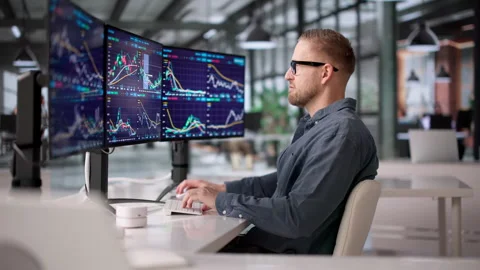 Trader Using Multiple Computer Screens Stock Footage 331150117