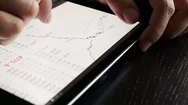 Trader Using Tablet For Checking Stock Data. Close Up. Stock Footage