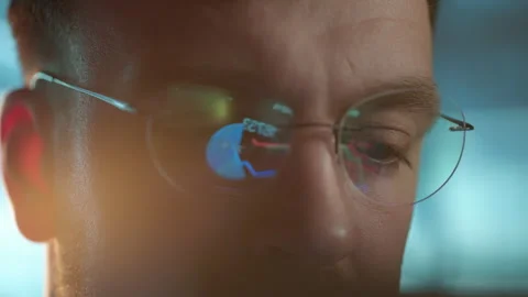 Trader wearing glasses is working on laptop computer. Screen with stock market Stock Footage 317201039
