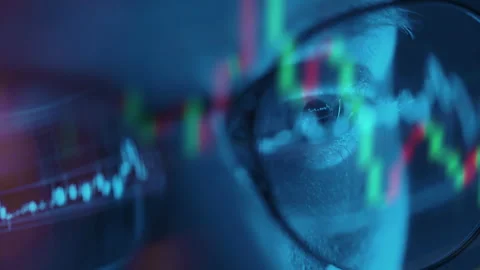 Trader wearing glasses is working on laptop computer. Screen with stock market Stock Footage 317213285