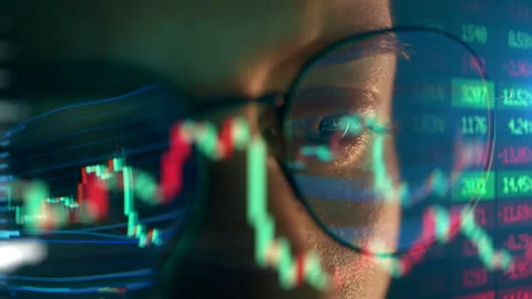 Trader wearing glasses is working on laptop computer. Screen with stock market Stock Footage 318965401