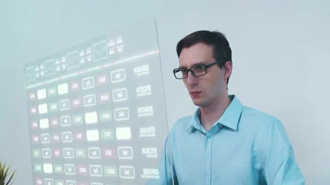 Trader is working on a computer with futuristic transparent monitor full of Stock Footage 172093681