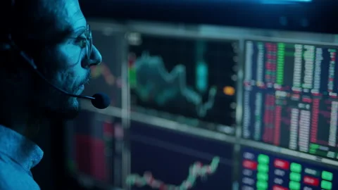 Trader is working with multiple computer screens with charts and data analysis Stock Footage 156703623