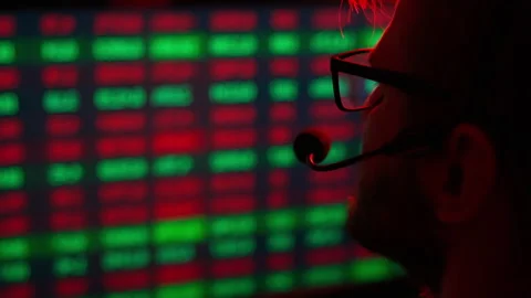 Trader is working with multiple computer screens with charts and data analysis Stock Footage 168976363