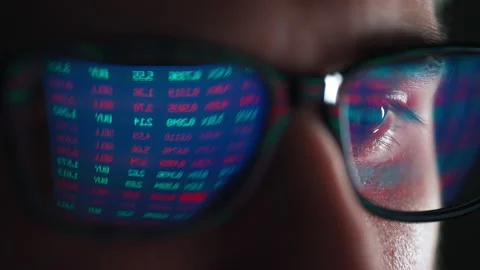 Trader is working with multiple computer screens with charts and data analysis Stock Footage 188444831