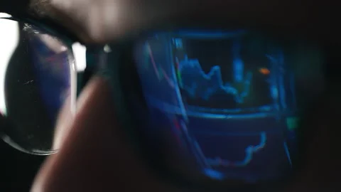 Trader is working with multiple computer screens with charts and data analysis Stock Footage 188446084