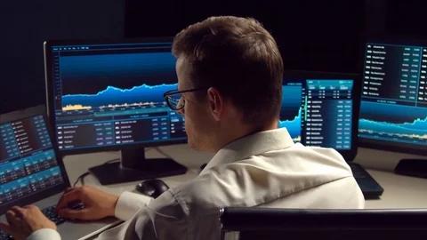 Trader working in office at night using workstation and analysis technology Stock Footage 119402876