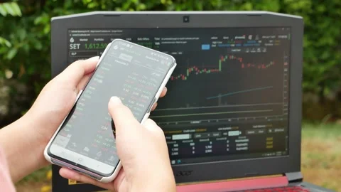 Trader working with tablet and notebook on stock market trading. Stock Footage 157687758