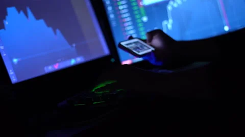 A trader works with a computer. Screen with stock charts and data analysis. Stock Footage 262975943