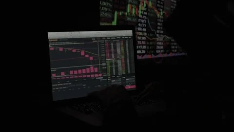 The trader works with electronic reports on the rates of crypto currencies. The Stock Footage 84843750