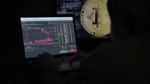 The trader works with electronic reports on the rates of crypto currencies. The Stock Footage 84844092