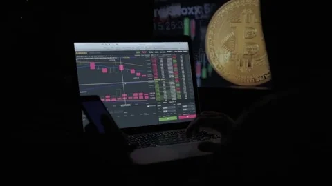 The trader works with electronic reports on the rates of crypto currencies. The Stock Footage 84844335