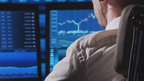 Trader works in office using workstation and analysis technology. Workplace of Stock Footage 306947997