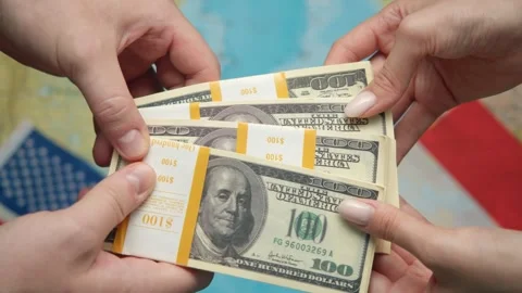 Traders formalize dollar transaction against maps and US-French flags for Video stock 331263902