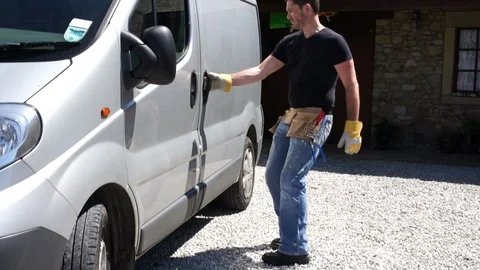 Tradesman gets tool box out of his van. Plumber / Joiner/ Electrician at vehicle Stock Footage