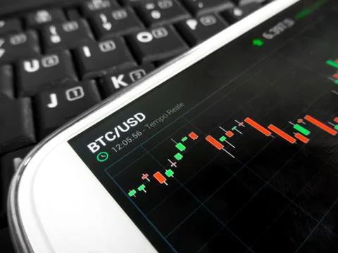 Trading bitcoins using a smartphone Stock Photos