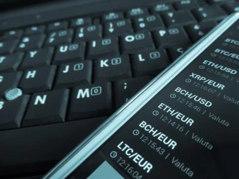 Trading bitcoins using a smartphone Stock Photos