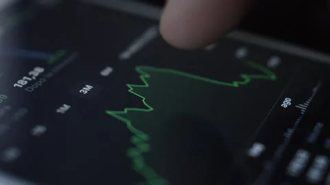 Trading chart analysis. businessman analysis trading chart on iphone screen. Stock Footage 248686209