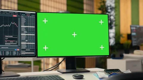 Trading platform interface in prop firm office with graphs on green screen PC Stock Photos
