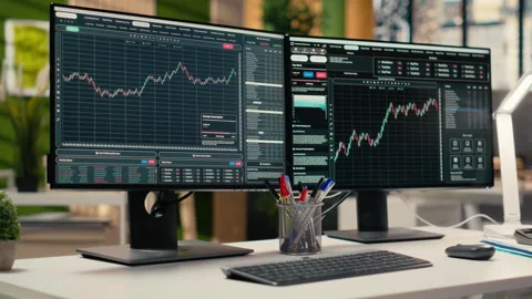 Trading software in prop firm office with price graphs on screens Stock Footage 315155503