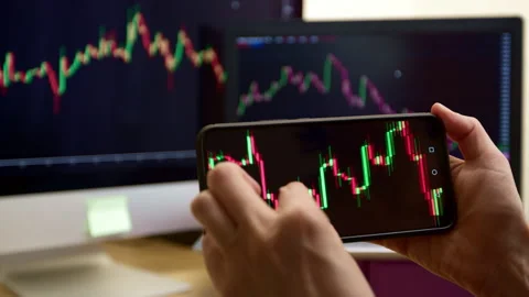 Trading using a smartphone. Stock quotes futures on the phone screen.  Stock Footage 240729926
