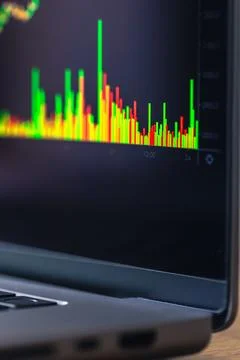Trading volume bars on laptop screen. Financial market data in close detail. Stock Photos