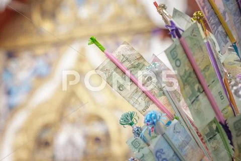 Tradition of buddhist festival; banknotes with a decorative timber for donati Stock Photos