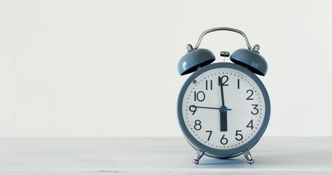 The traditional alarm clock on white table and time  setting of 6 AM morning Stock Footage 92193579