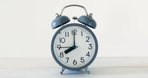 The traditional alarm clock on white table with time  setting of 8 PM wake up Stock Footage 92233958