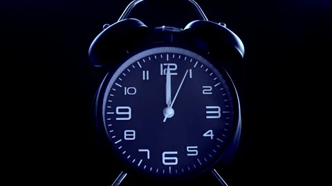 Traditional analog alarm clock with blue face, bells ringing at 12 o’clock. Stock Footage 200874545