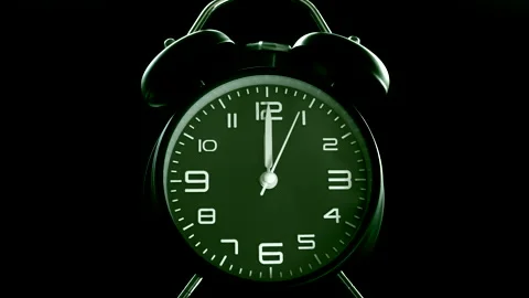 Traditional analog alarm clock with green face, bells ringing at 12 o’clock. Stock Footage 200874182