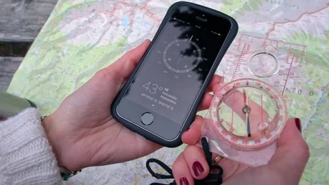 Traditional Analog and Digital Compass as the Phone App in the Female hands Stock Footage 83015727