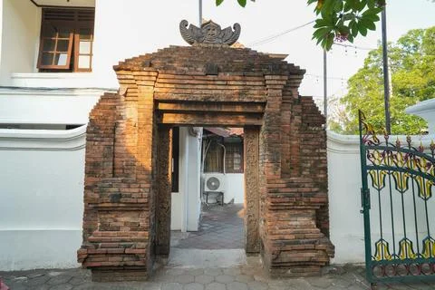 Traditional ancient red brick gate entrance of a Javanese building. Stock Photos